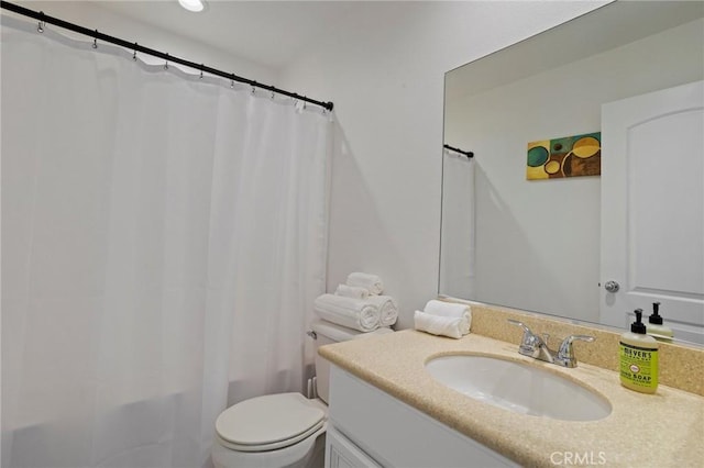 bathroom with vanity, curtained shower, and toilet