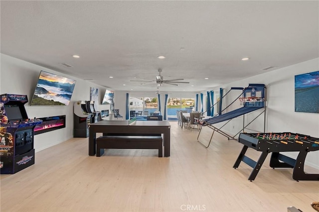 rec room featuring ceiling fan and light hardwood / wood-style flooring