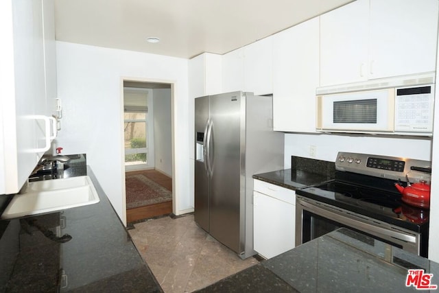 kitchen with stainless steel appliances, sink, and white cabinets