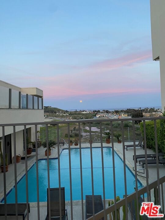 view of pool at dusk