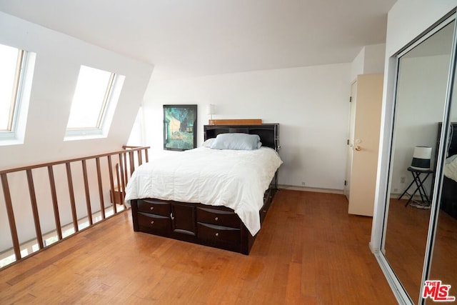 bedroom featuring wood-type flooring and a closet