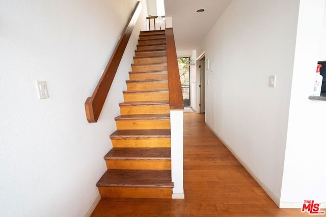 stairs with hardwood / wood-style flooring