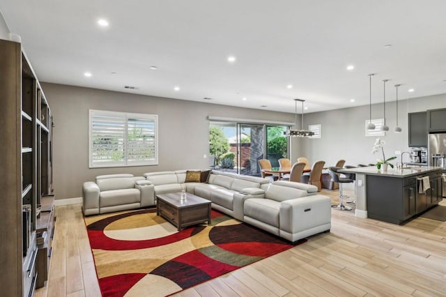 living room featuring sink and light wood-type flooring