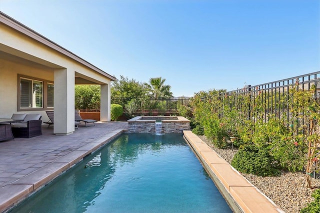 view of swimming pool with an in ground hot tub and a patio area