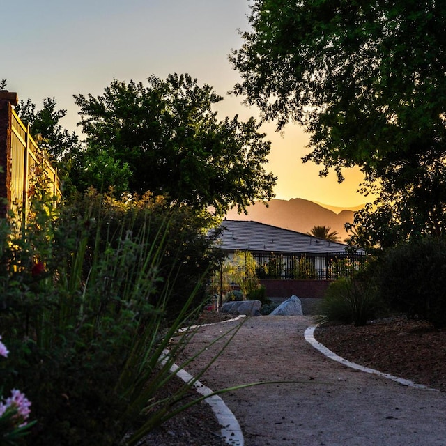 yard at dusk featuring a mountain view