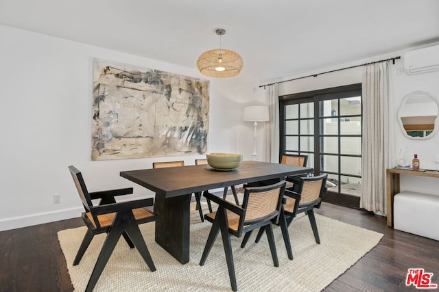 dining area with a wall mounted air conditioner and dark hardwood / wood-style flooring