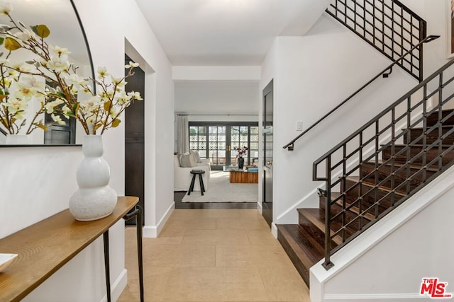 entrance foyer featuring light tile patterned floors