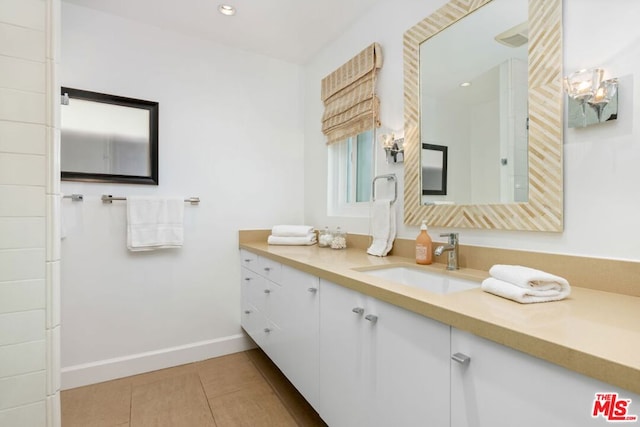 bathroom with tile patterned floors and vanity