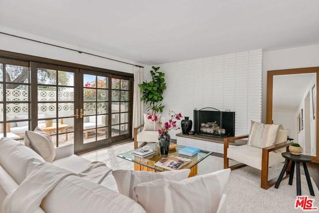 living room with a brick fireplace and french doors