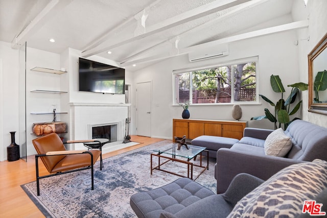 living room featuring a wall mounted AC, a textured ceiling, light hardwood / wood-style flooring, and vaulted ceiling with beams