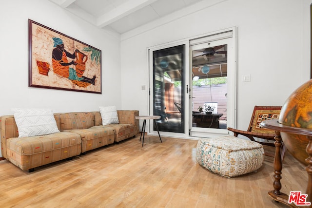 living room with wood-type flooring and lofted ceiling with beams