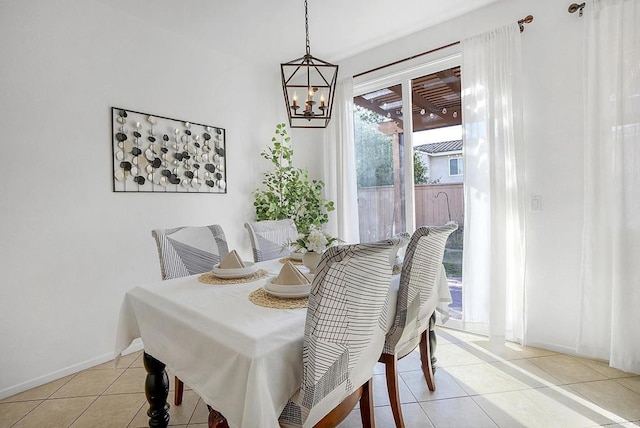 dining area with light tile patterned flooring and a notable chandelier