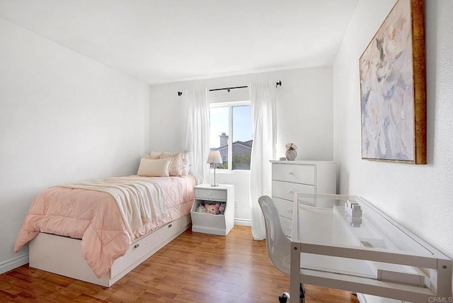 bedroom with hardwood / wood-style floors