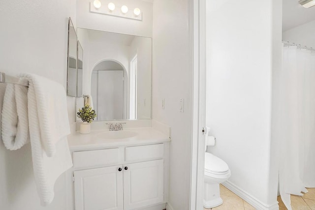 bathroom featuring tile patterned floors, vanity, and toilet