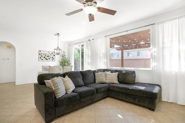 tiled living room with ceiling fan