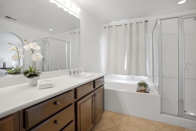 bathroom featuring vanity, shower with separate bathtub, and tile patterned floors