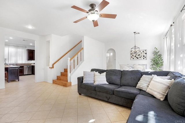 living room with light tile patterned floors and ceiling fan