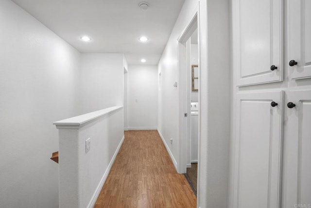 corridor with light hardwood / wood-style floors