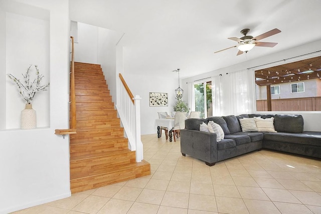 living room with light tile patterned floors and ceiling fan