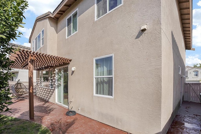 view of side of property with a patio and a pergola