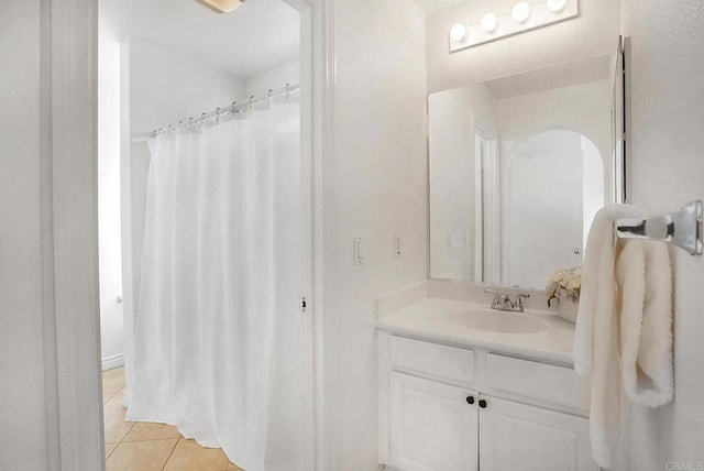 bathroom featuring vanity, curtained shower, and tile patterned flooring