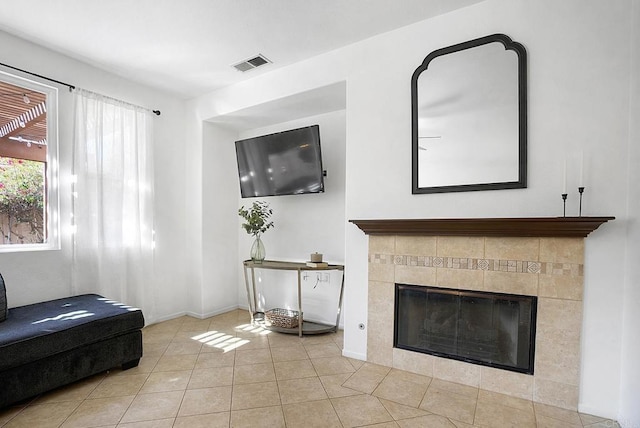 living room with light tile patterned flooring and a fireplace