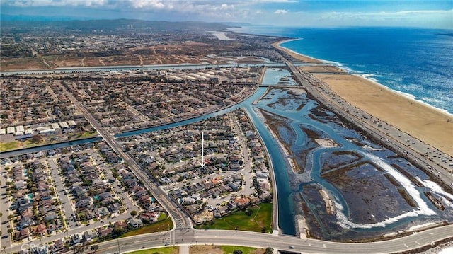 drone / aerial view with a beach view and a water view