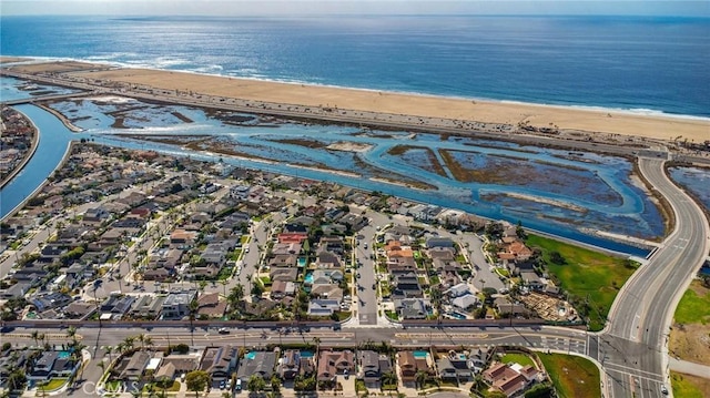 drone / aerial view featuring a water view and a view of the beach