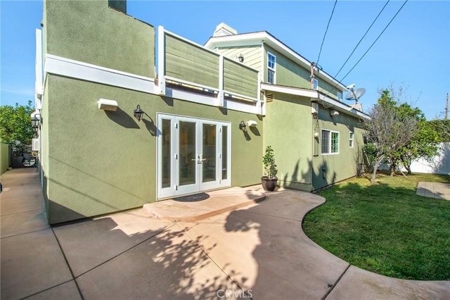 22052 Susan Ln, Huntington Beach, CA 92646 - rear view of house featuring french doors, a patio, stucco siding, and a yard