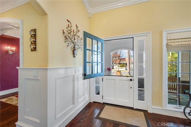 entryway featuring a decorative wall, dark wood-style flooring, plenty of natural light, and crown molding