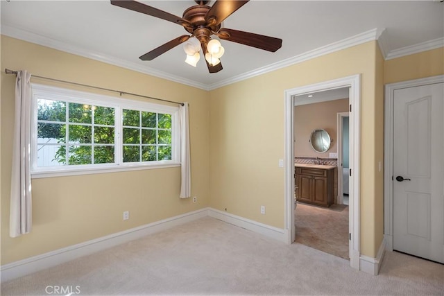 unfurnished bedroom featuring light carpet, ceiling fan, ornamental molding, and baseboards