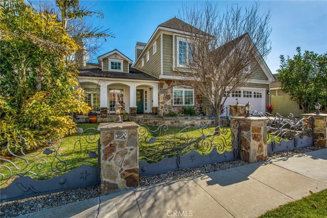 22052 Susan Ln, Huntington Beach, CA 92646 - view of front of property featuring stone siding, a garage, and covered porch