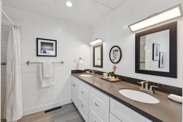 bathroom with vanity and wood-type flooring