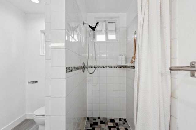 bathroom featuring toilet and a shower with shower curtain