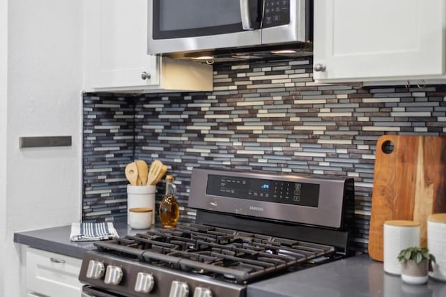 kitchen featuring white cabinetry, appliances with stainless steel finishes, and tasteful backsplash