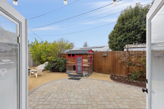 view of patio / terrace with a storage shed