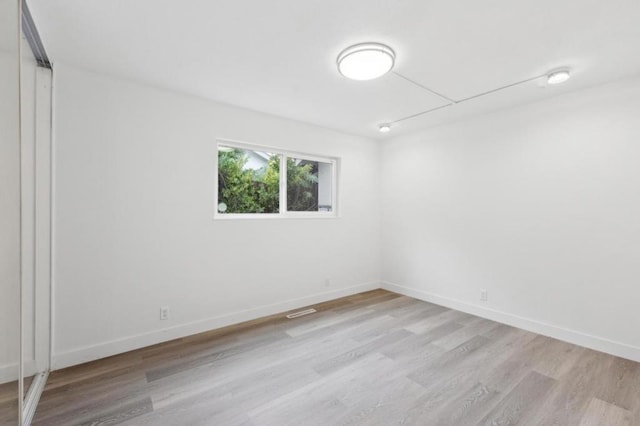 spare room featuring light hardwood / wood-style flooring