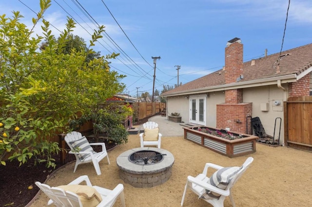 exterior space featuring french doors, a patio area, and an outdoor fire pit