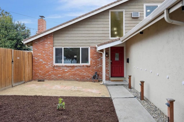 view of exterior entry featuring a patio