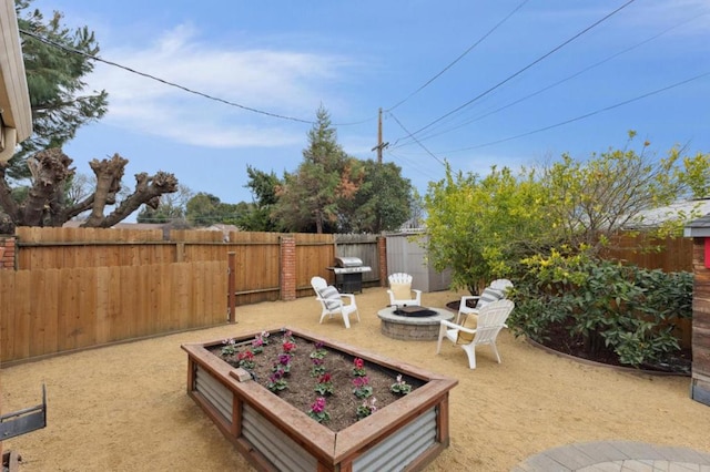 view of patio featuring a storage unit and an outdoor fire pit