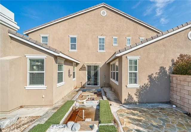 rear view of house featuring a patio