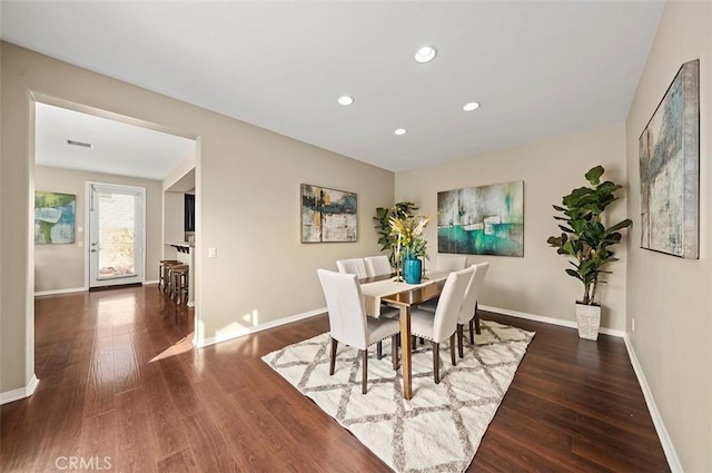 dining room with dark hardwood / wood-style flooring