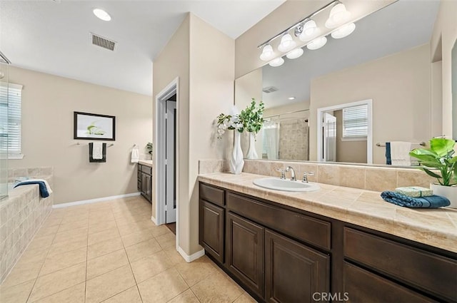 bathroom featuring tile patterned flooring, vanity, and plus walk in shower