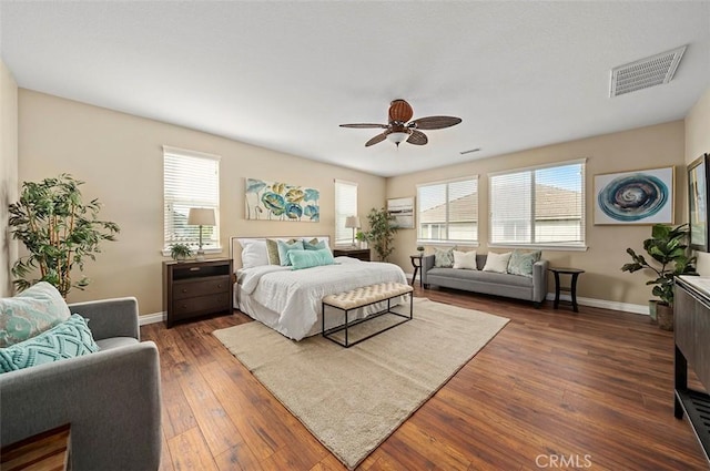 bedroom with dark hardwood / wood-style flooring and ceiling fan