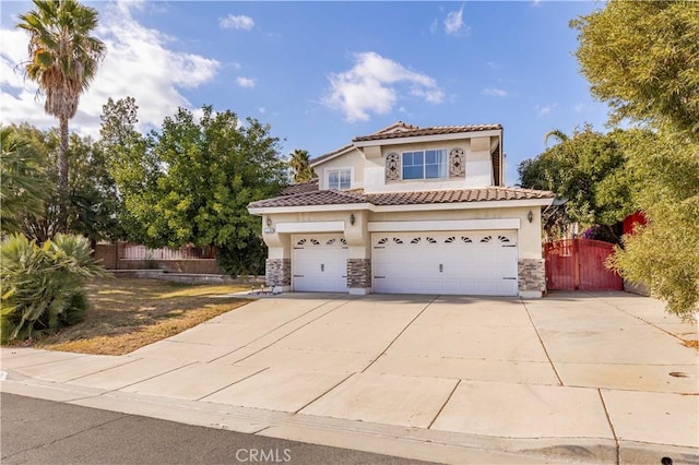 mediterranean / spanish house with a garage