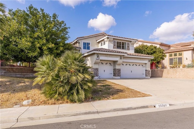 mediterranean / spanish house with a garage