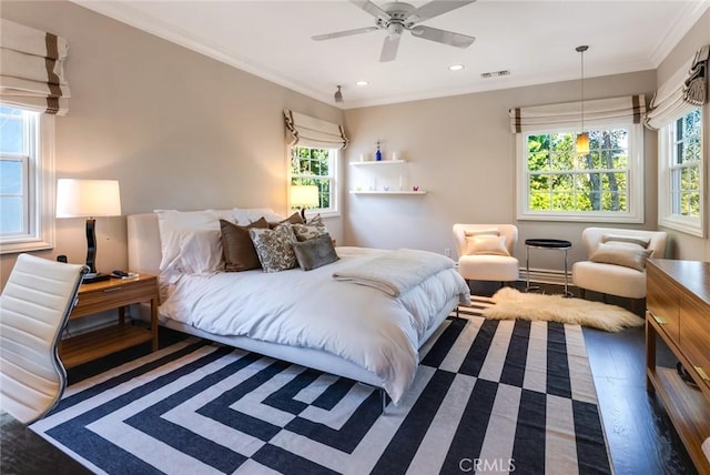 bedroom featuring crown molding, dark hardwood / wood-style floors, and ceiling fan