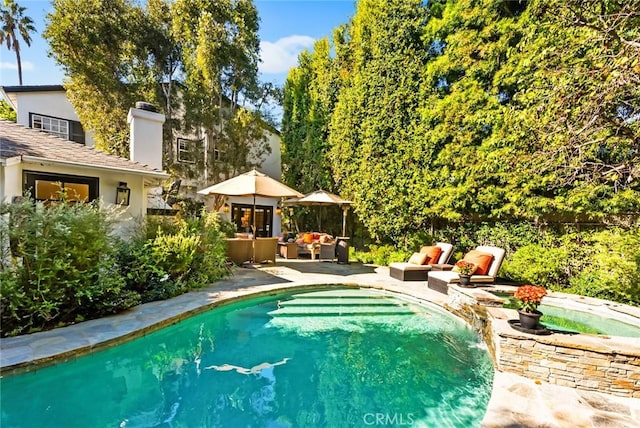 view of pool featuring an outdoor hangout area and a patio