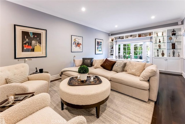 living room featuring hardwood / wood-style flooring, ornamental molding, and french doors