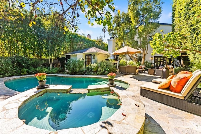 view of pool with a patio and an outdoor hangout area